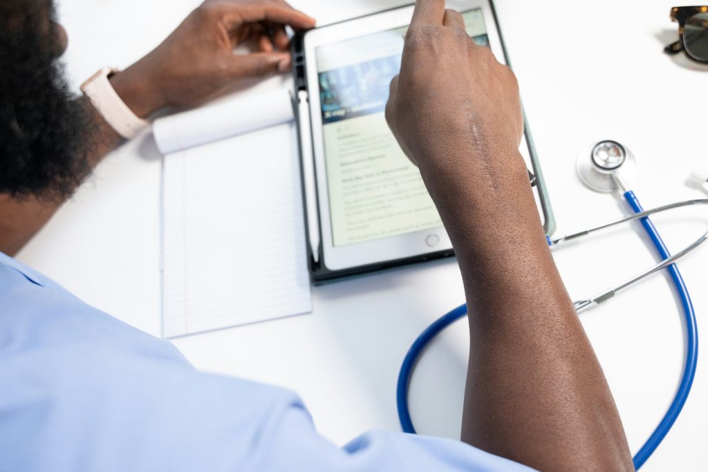 Medical professional reviewing secure digital health records to maintain HIPAA compliance.